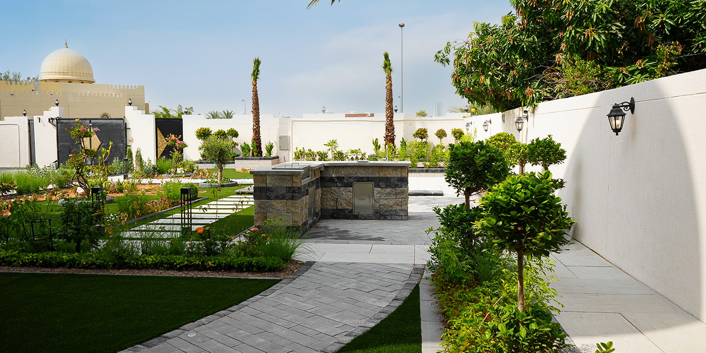 Outdoor living space with pergolas for shade, outdoor kitchen for outdoor cooking and outdoor seating space in Dubai, UAE.